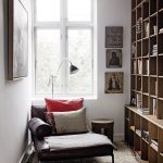 amazing dedicated space to read with cozy leather reading nook and wonderful giant wooden book shelves with elegant white wall in warm fur rug