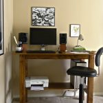hardwood standing table flat-computer-screen and keyboard twin black audio system steel table lamp  height-adjustable office chair printer unit black-white mode painting