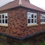 three units of cottage style windows with wood trims red and dark bricks for wall