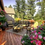 Better Homes and Gardens’ landscape design for back deck a set of outdoor furniture with hanging pot for decorative plants a floral patterns carpet