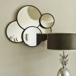 layered round sheffield home mirrors  in white paint wall plus stylish table lamps