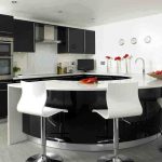 simple  kitchen design with half round kitchen island with sink and faucet plus white barstools white countertop with white tiles backsplash black painted cabinets modern kitchen utensils