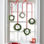 Green wreaths as Christmas decorations hung on window’s top