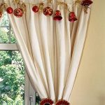 Red Christmas balls and red mini bells as window curtain ornaments