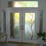 White elegant door with tree pattern stain glass panel and sidelights