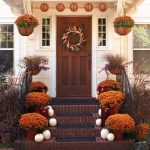 adorable entrance outdoor thanksgiving decoration idea with fall flower on staircase before wooden door with wreath