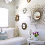 gorgeous white loft living space idea with white cream banquette beneath glass window with sun wall mirror and half circle coffee table for nicole miller home decor