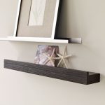 metal picture ledge shelf decorated with wooden picture ledge shelf mounted on wall with star fish decorations and photoframe