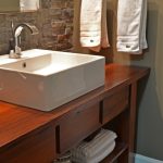 Bathroom Rustic Style With White Pegasus Vanity Tops And Sink Wooden Cabinet Towel Hanger Stone Wall