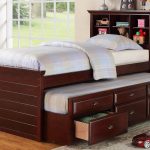 Dark brown trundle with bookcase in headboard a pull out bed and drawer system