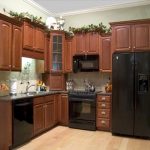 Wall and base kitchen clearance made from wood a black refrigerator appliance some electric kitchen appliances