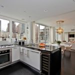 downtown living room with kitchen design with black white cabinetry and white sofa and open plan and city view