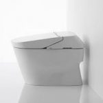 small and elegant white heated toilet seat with unique shape beneath white wall