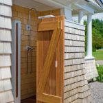 Semi outdoor shower room with wooden door free standing showerhead