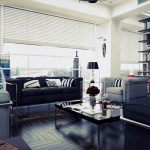 adorable spacious living room designidea with light black coffee table and black sofa and gray sofa and floor to ceiling sehlves and glass window with rolled drape