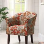 cool accent chairs with orange leaf motif plus wooden leg and comfy back and arms