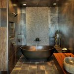 great asian interior style with metallic bathtub and wooden vanity and tile rustic flooring and concrete wall siding and gloomy lighting