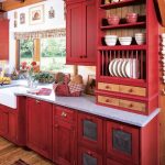 small L shaped red country kitchen design with white top and glass window and french curtain and wooden floor and patterned runner rug