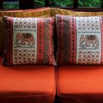 stunning elephant print on rustic cushion with ethnic pattern on orange modern sofa design