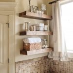 elegant bathroom design with bold wooden shelves design and small tiles mosaic backsplash and modern bathtub