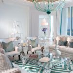 gorgeous white and green patterned scandinavian boho chic style with all white seating and unique turquoise chandelier and glass table