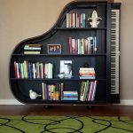 unique cool bookshelves design in black color with piano shape on wooden floor with green rug
