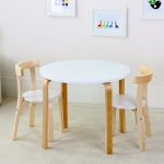 white round top table and a pair of wood chairs with white round seat and semi round backrest