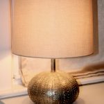 Gold sea urchin baselamp with light cream lampshade