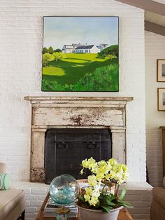 Delightful Fireplace with Ornamental Accent on White Concrete Wall Painted in White Combining Landscape Paintings and Steel Panel for Mantel
