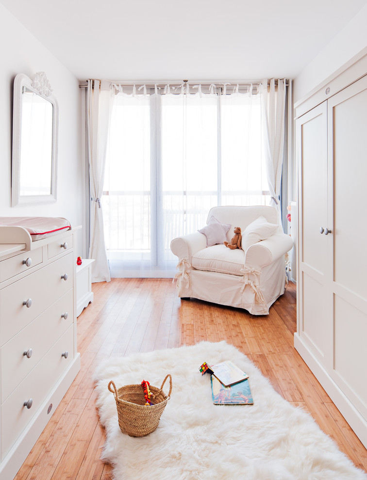 light palettea nursery idea medium toned wood floors white nursery chair slipcover white changing table with drawer system white framed mirror white window curtains