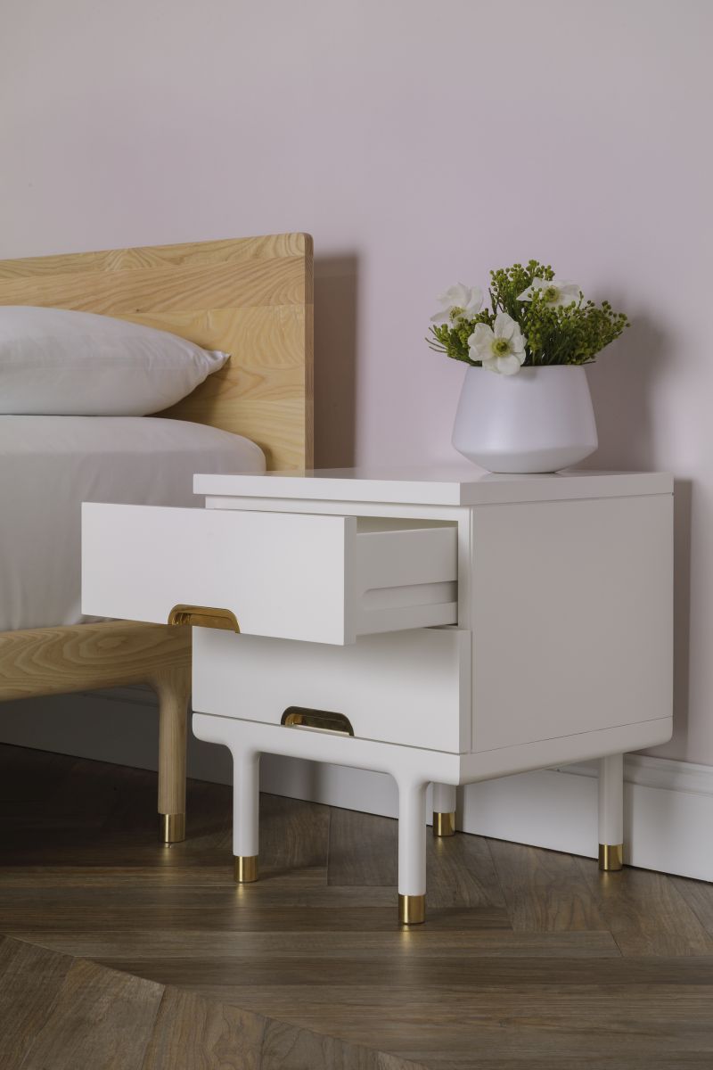 white finishing side table with gold accents on legs and drawers' bottom