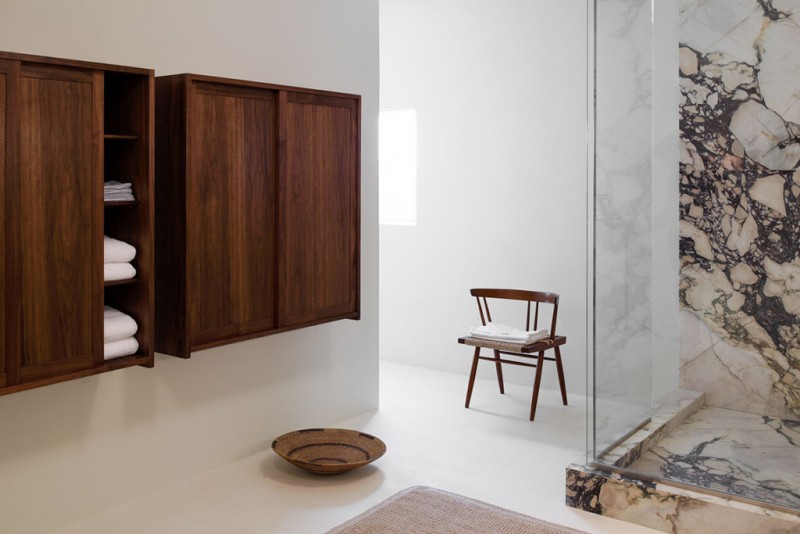 open concept bathroom scandinavian style wood chair walk in shower with clear glass enclosure and marble interior hardwood closet
