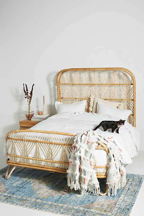 hancrafted rattan bed frame with headboard by Anthropologie