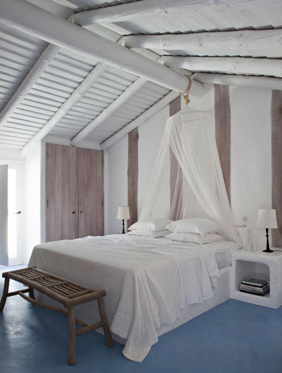 white painted wood beams and ceilings all white bedding treatment white canopy curtains wood bench bed blue floors