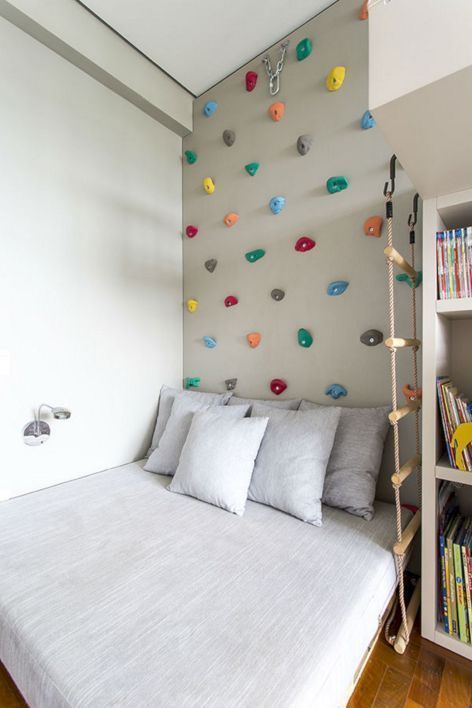 Montessori themed boy's room crisp white bed linen and pillows white book shelves