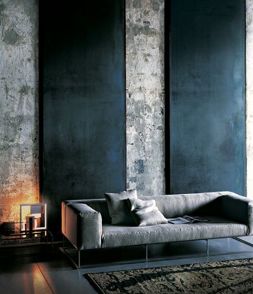 concrete walls featuring matte black walls concrete colored sofa with throw pillows
