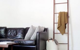 black leather sofa with gray throw pillows ladder rack