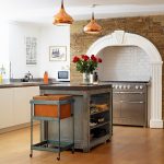 ecletic kitchen renovation with  glittering pendant lamp also interesting wall brick feat beautiful rose in glass pot also silvery dishwasher in laminate flooring idea