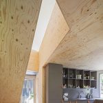 plywood wall plywood ceiling gray minimalist kitchen cabinet irregular house structure glassed door colorful doormat affordable modern prefab house by Tommy Carlsson
