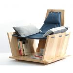 very distinctive reading chair design made from solid wood with under shelving books
