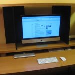 wood –finishing top monitor desk a wireless keyboard a wireless computer mouse Apple notebook