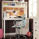 cute decoration of study desk for girl student with under cabinet drawer and top bookshelf in white color a blue movable chair with white polkadot patterns a cute pink trash container some ornaments