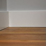wide baseboard in white color solid wood flooring