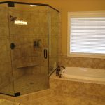 modern bathroom remodel with a floating bench a planted showerhead appliance and a built-in shelf inside a glass door shower room a built-in bathtub with water sprayer a small console for towel storage