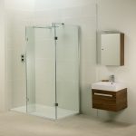 small walk-in shower with  glass door panels  small and minimalist floating bathroom vanity with square sink and faucet a floating single cabinet with mirror door