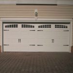 two car garage door with gray color solid wood material together with windows on top plus wall scones and impresive wall