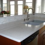 white ceramic tile countertop with a deep sink and metal faucet
