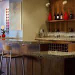 Luxurious home wine bar design with wood wall system and wood shelf for wine bottle collections two barstools with backrest