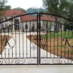large and luxurious wrought iron main gate with letter initial