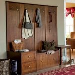 mudroom storage units in solid wooden with drawers and hanging clothes plus red rug and loundry basket home furniture ideas